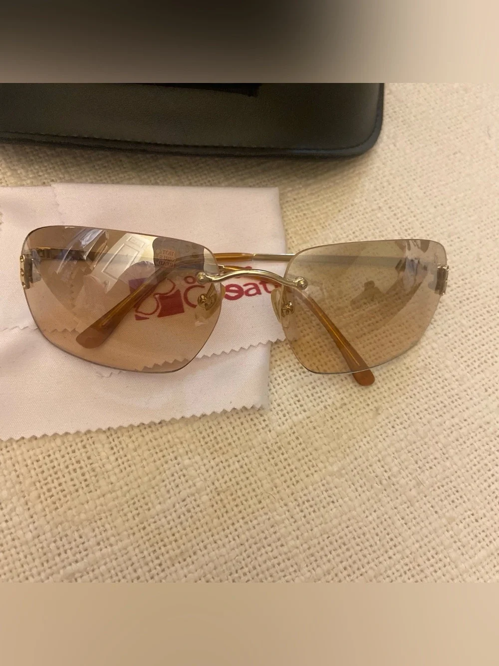 2000s style creative optics sunglasses with brown lenses and gold frames